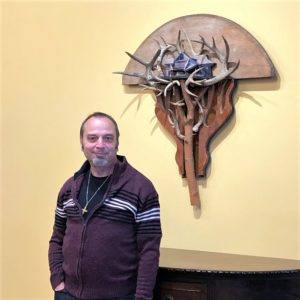 Artist Bret Hines with Antler House Re-found objects Assemblage Artwork