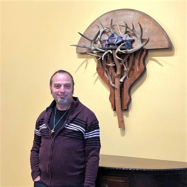 Artist Bret Hines with Antler House Re-found objects Assemblage Artwork